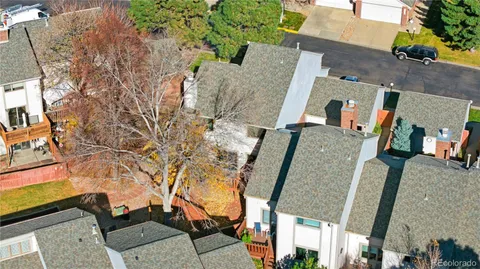 an aerial view of a tennis ground and a yard