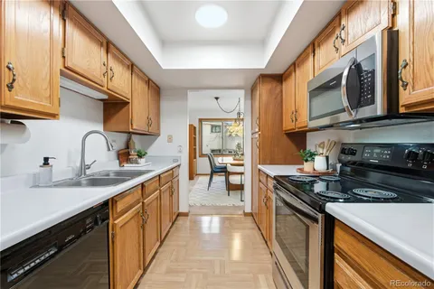 a kitchen with stainless steel appliances granite countertop a sink stove and cabinets