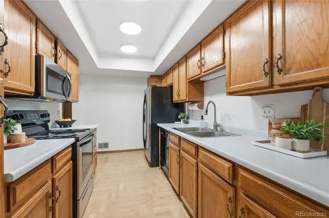 a kitchen with stainless steel appliances granite countertop a sink stove and cabinets