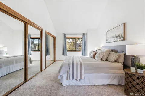 a bedroom with a large bed and a window