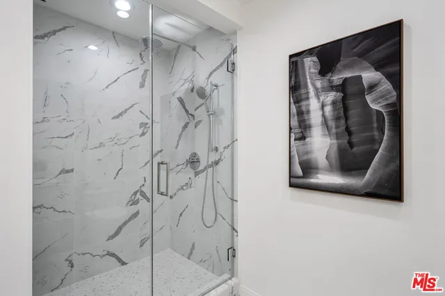 a picture of a bathroom with a shower and a mirror