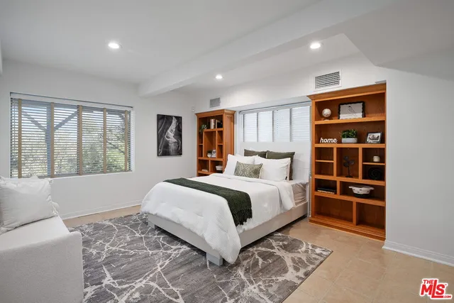 a bedroom with a large bed and a window