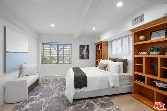 a bedroom with a large bed and a window