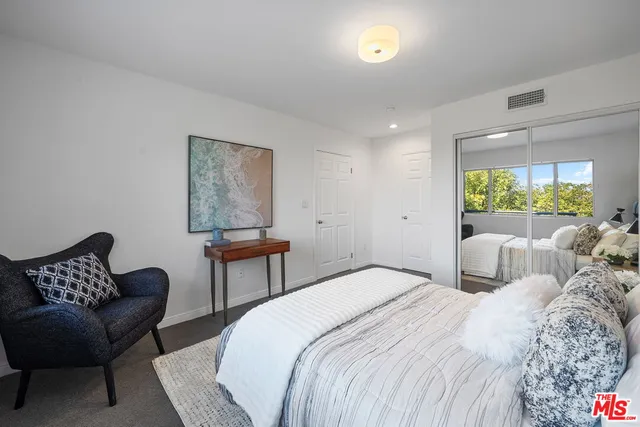 a bedroom with a bed and a couch