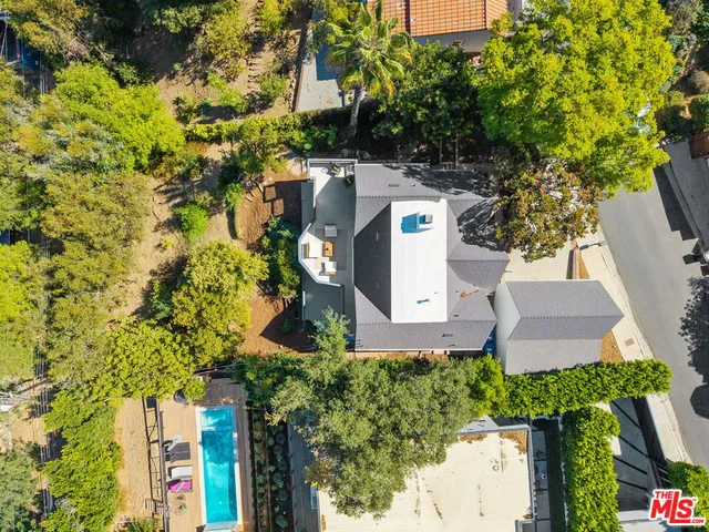 an aerial view of a house with a yard
