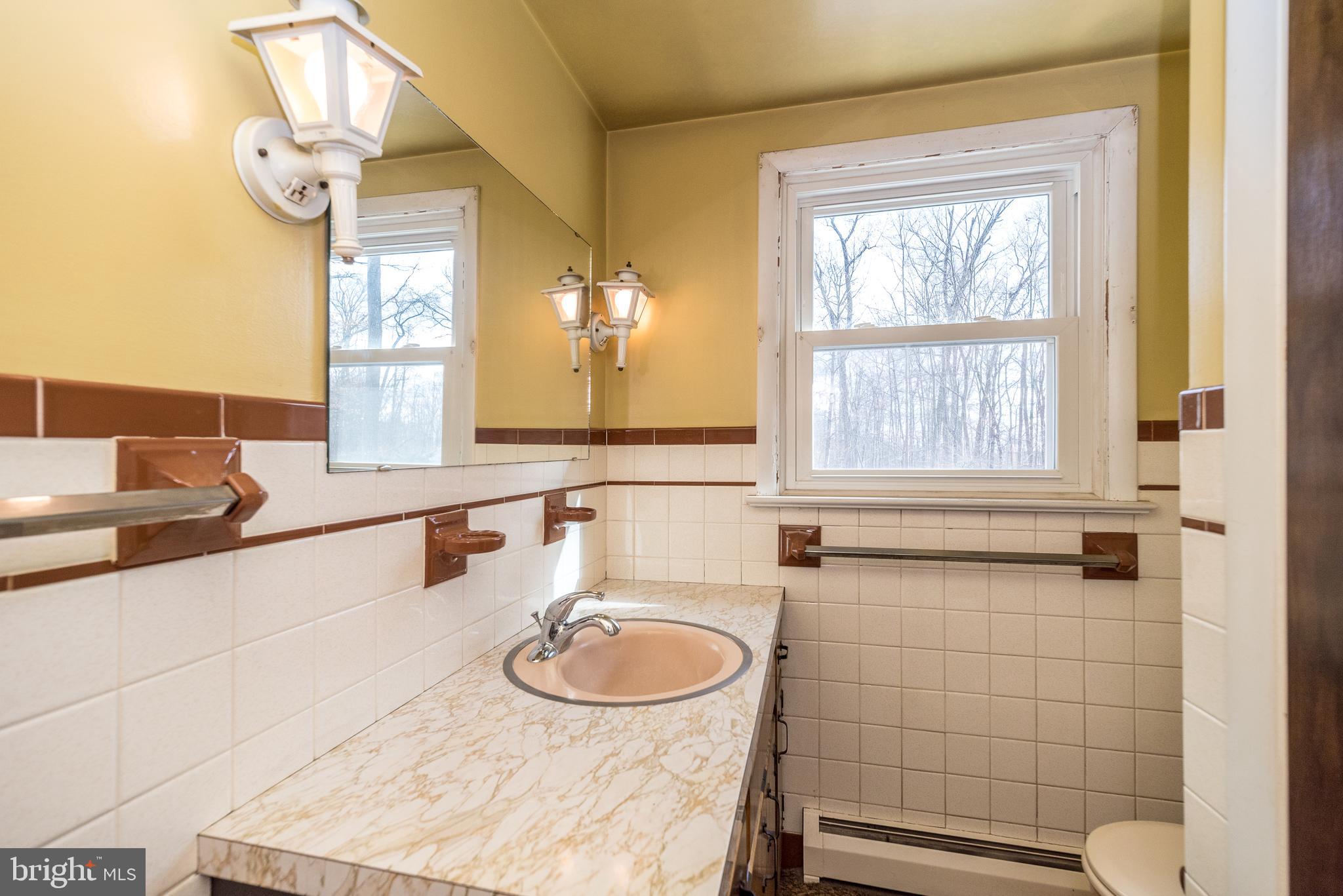 1962 Kepler Road Pottstown, PA 19464 - Photo 13 of 26 a bathroom with a sink and a mirror