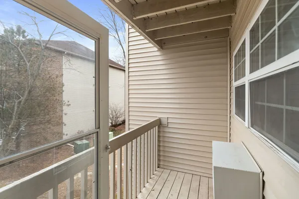 a view of a balcony with wooden floor and fence