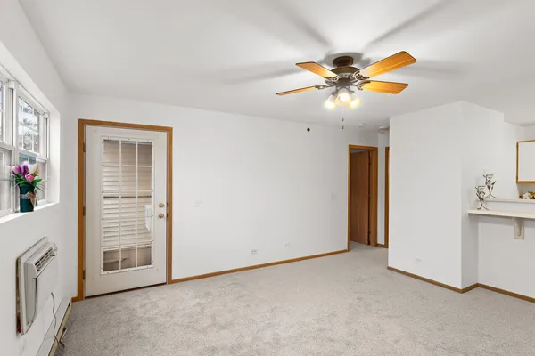 a view of a livingroom with a chandelier fan