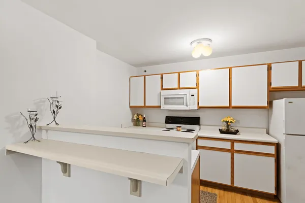 a kitchen with a sink cabinets and window