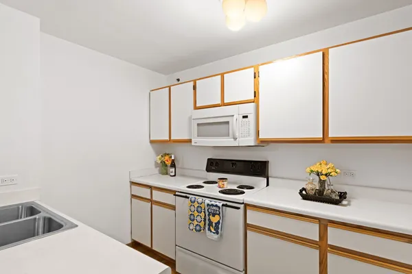 a kitchen with a sink cabinets and appliances