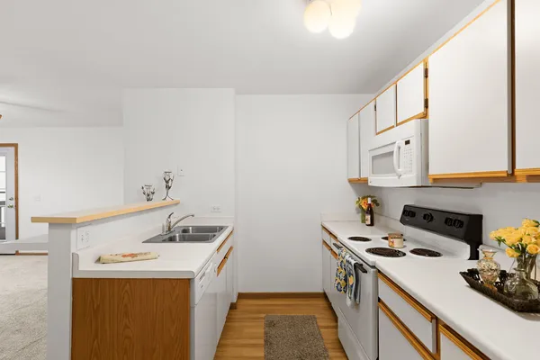 a utility room with cabinets washer and dryer