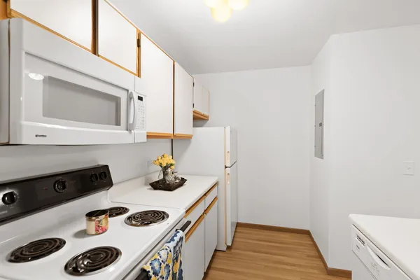 a kitchen with a refrigerator and a stove top oven