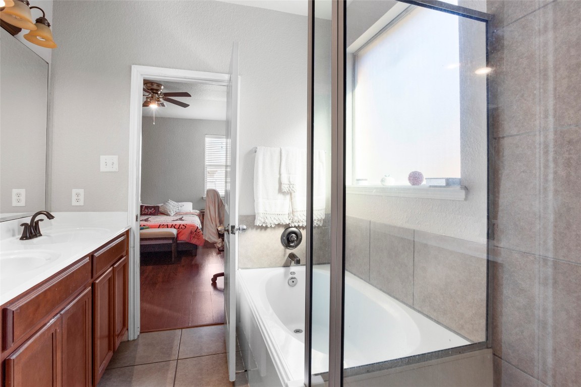 30 Supiro Drive Manvel, TX 77578 - Photo 15 of 30 a en suite bathroom with a granite countertop sink and a mirror