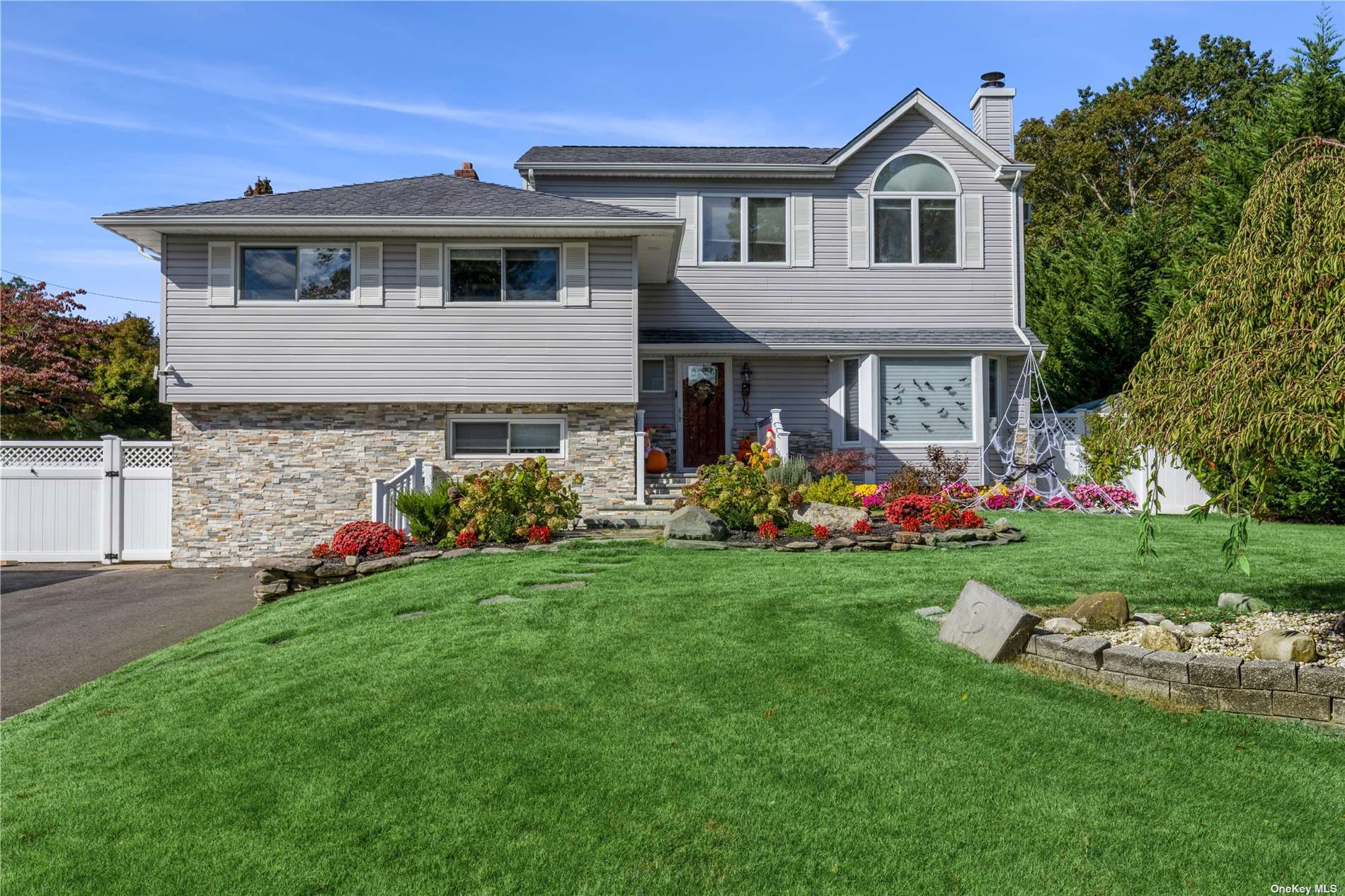 2 Amherst Lane Smithtown, NY 11787 - Photo 1 of 1 a front view of a house with a yard and garage