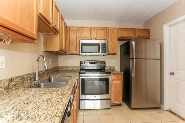 a kitchen with a refrigerator sink and microwave