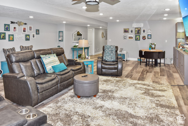 1500 Fish Creek Road Bancroft, ID 83217 - Photo 24 of 45 Living area featuring a textured ceiling, light wood finished floors, and recessed lighting