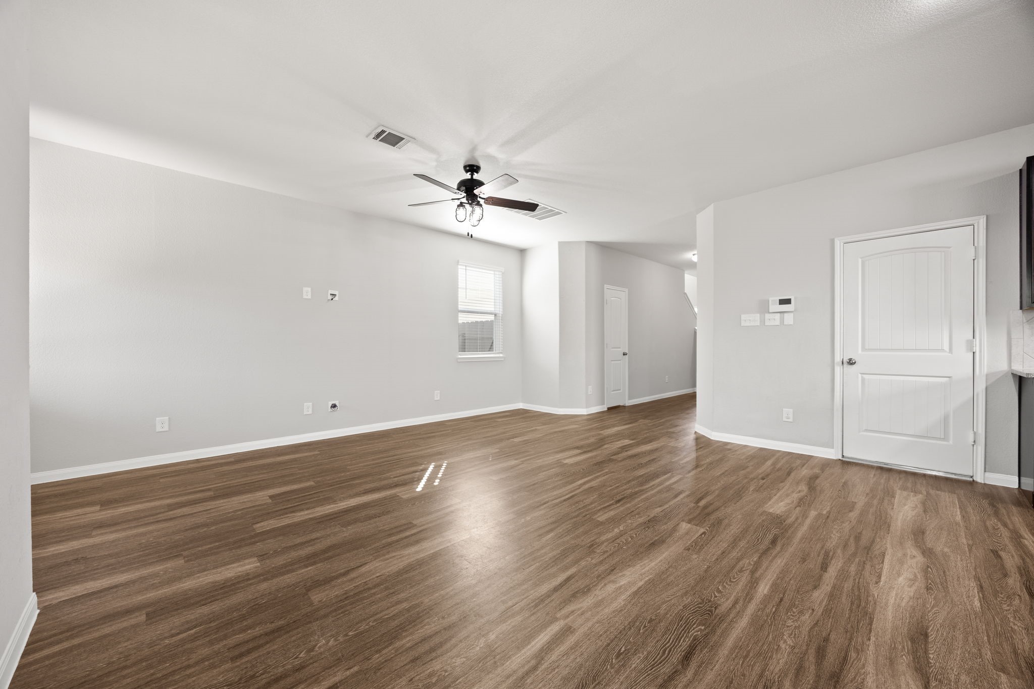 18606 Lansdowne Stream Path Katy, TX 77449 - Photo 18 of 39 an empty room with wooden floor and ceiling fan