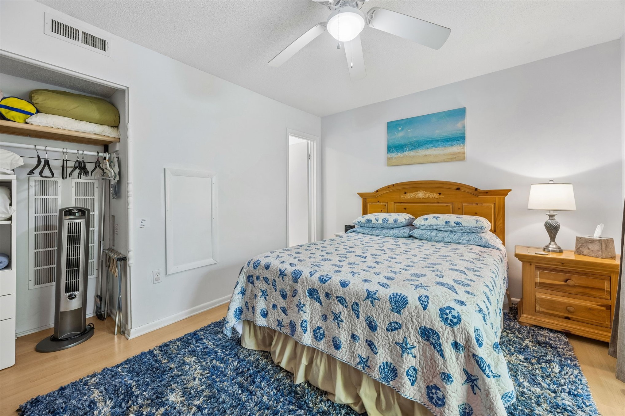 2328 Sadler Road, Unit 1C Fernandina Beach, FL 32034 - Photo 17 of 49 a bedroom with a bed and a chandelier