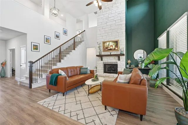 a living room with fireplace furniture and wooden floor