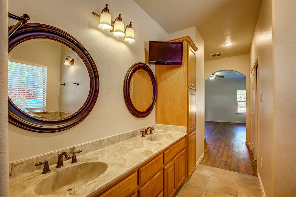 2617 Kirby Road Rowlett, TX 75088 - Photo 25 of 39 Bathroom with double vanity, a textured wall, ceiling fan, and light tile patterned floors