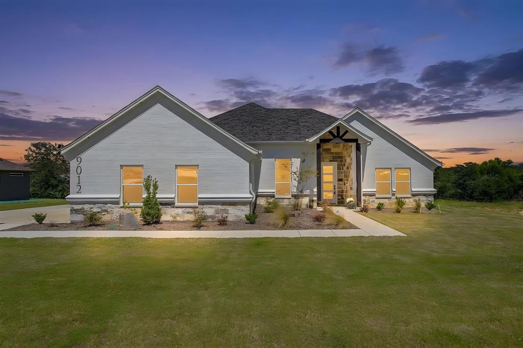 9012 Valley Oak Court Springtown, TX 76082 - Photo 2 of 40 a front view of house with yard and seating area