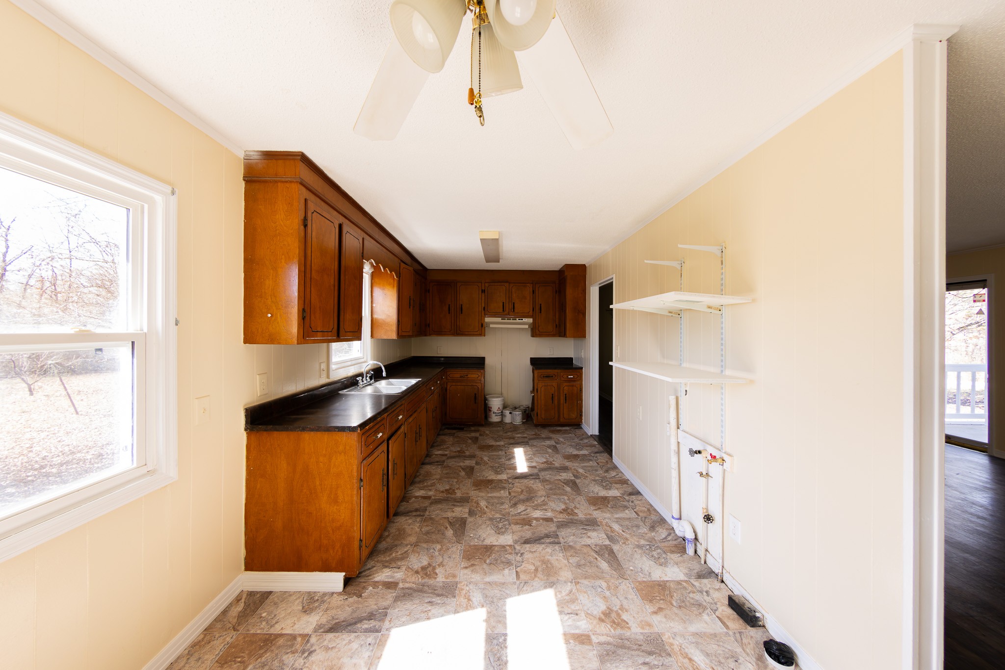 674 Switzerland Road Hohenwald, TN 38462 - Photo 13 of 38 a kitchen with granite countertop a refrigerator and a stove top oven