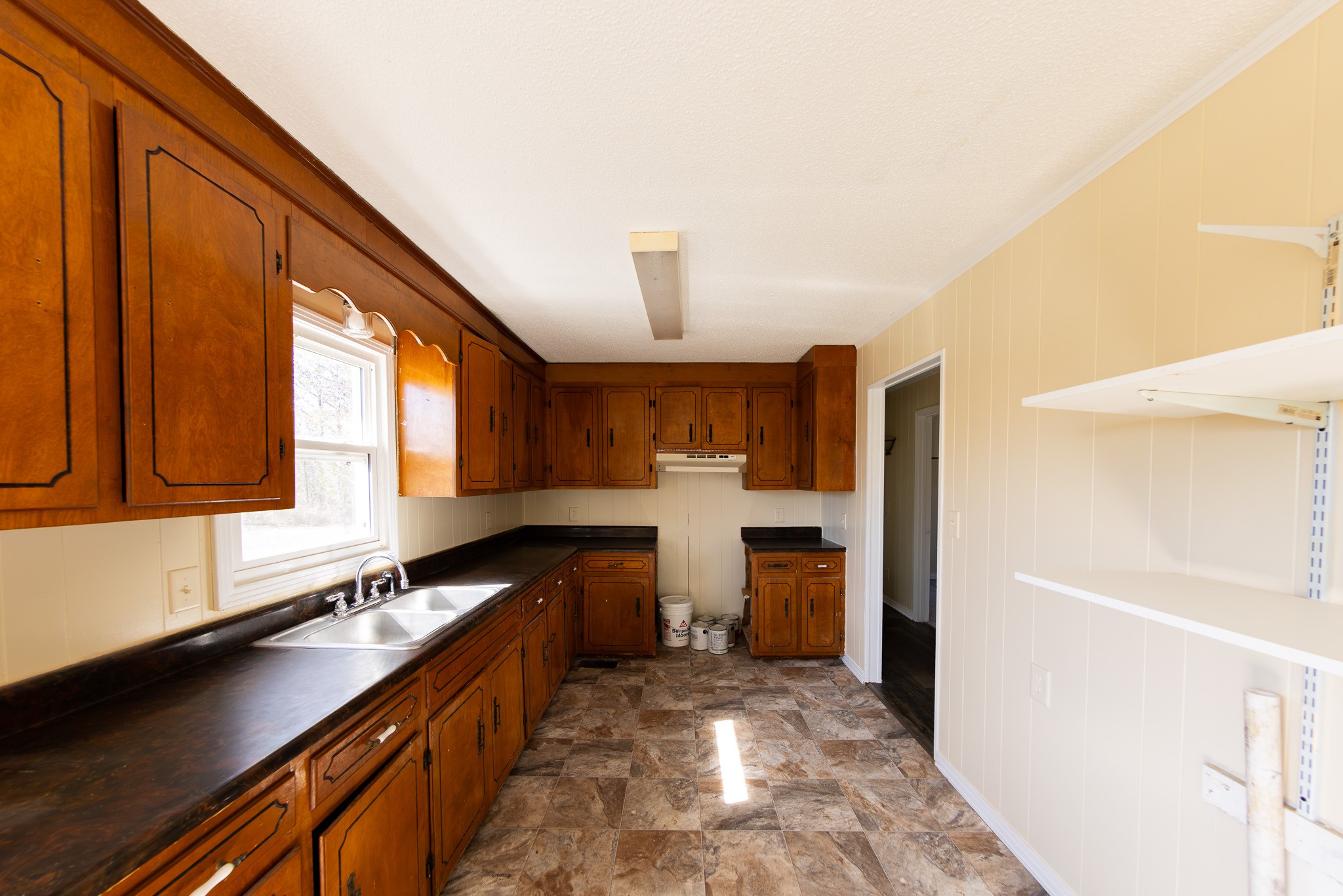 674 Switzerland Road Hohenwald, TN 38462 - Photo 14 of 38 a kitchen with a refrigerator and a sink