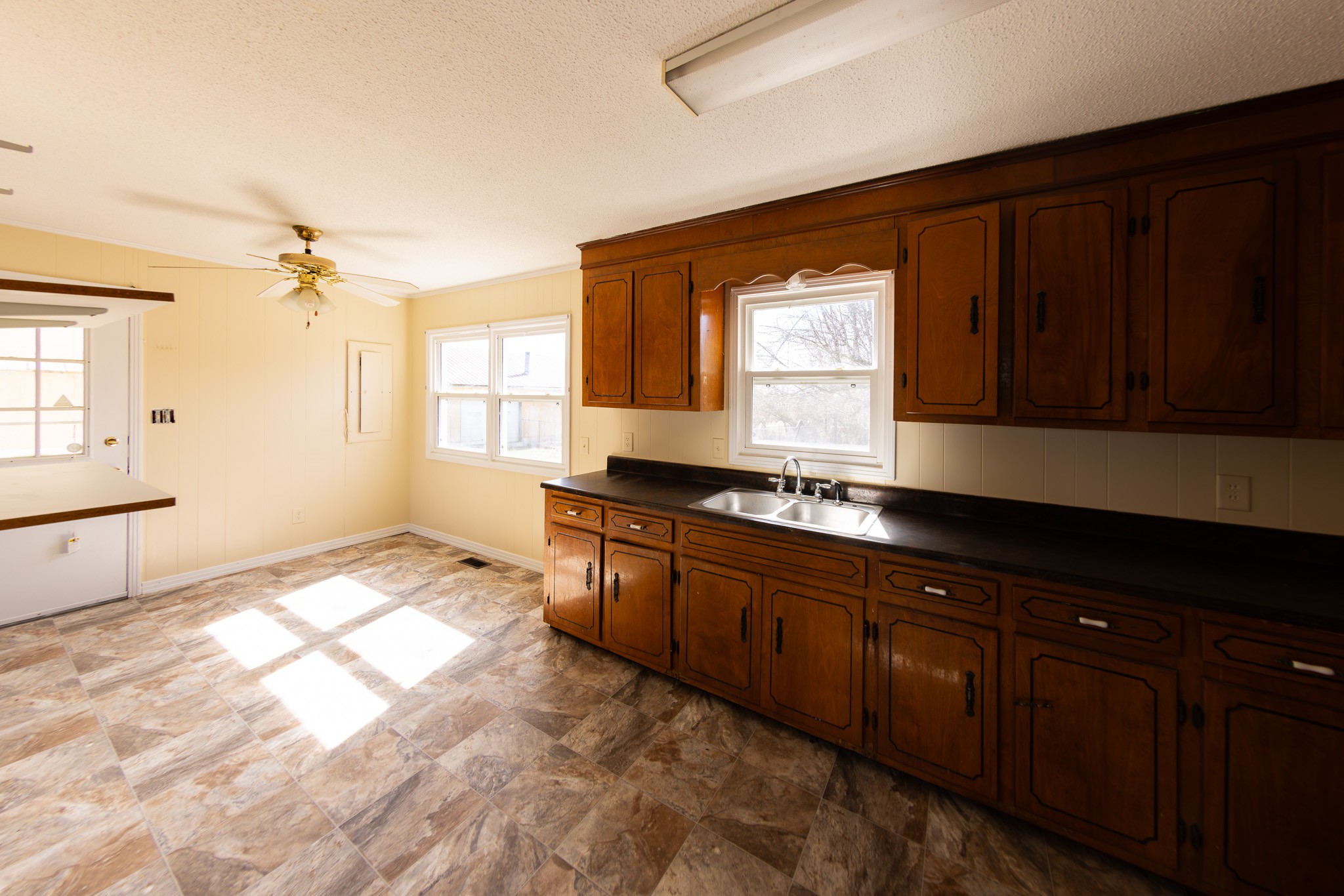 674 Switzerland Road Hohenwald, TN 38462 - Photo 16 of 38 a large kitchen with granite countertop wooden cabinets a granite counter top and a sink