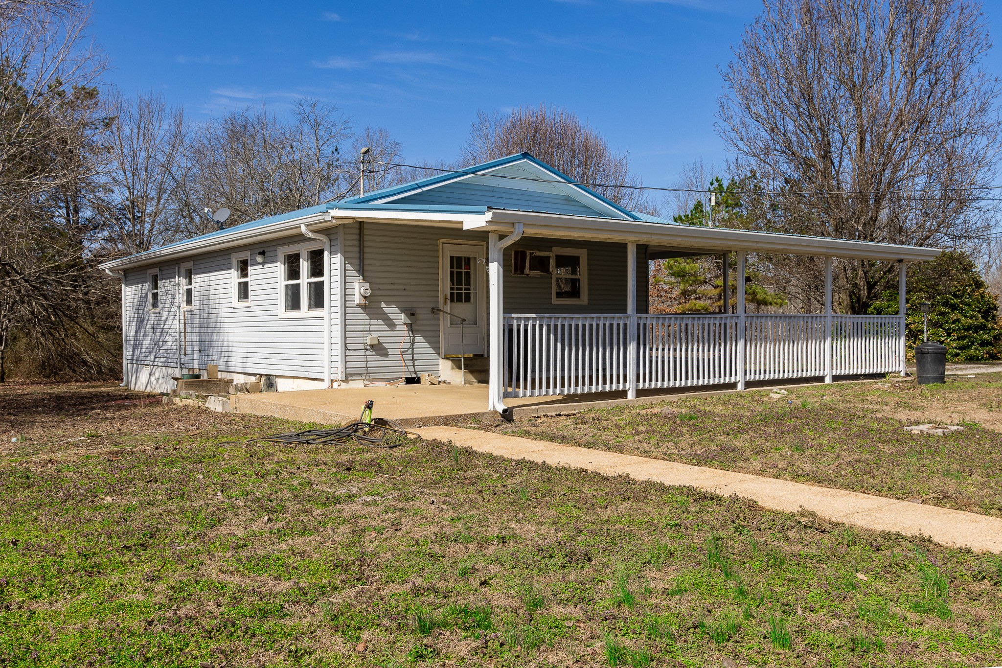 674 Switzerland Road Hohenwald, TN 38462 - Photo 4 of 38 a front view of a house with a yard