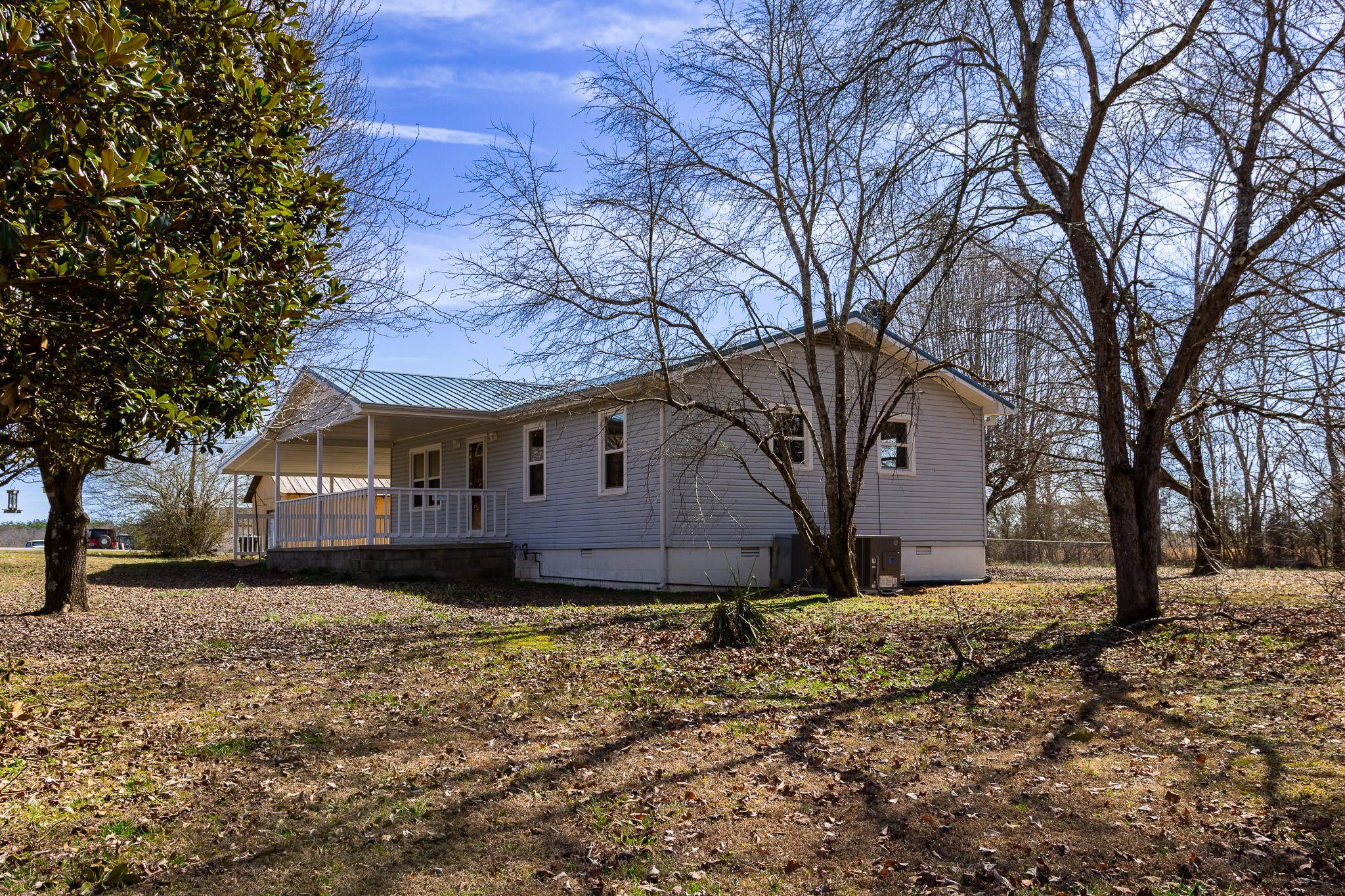 674 Switzerland Road Hohenwald, TN 38462 - Photo 6 of 38 a front view of a house with a yard