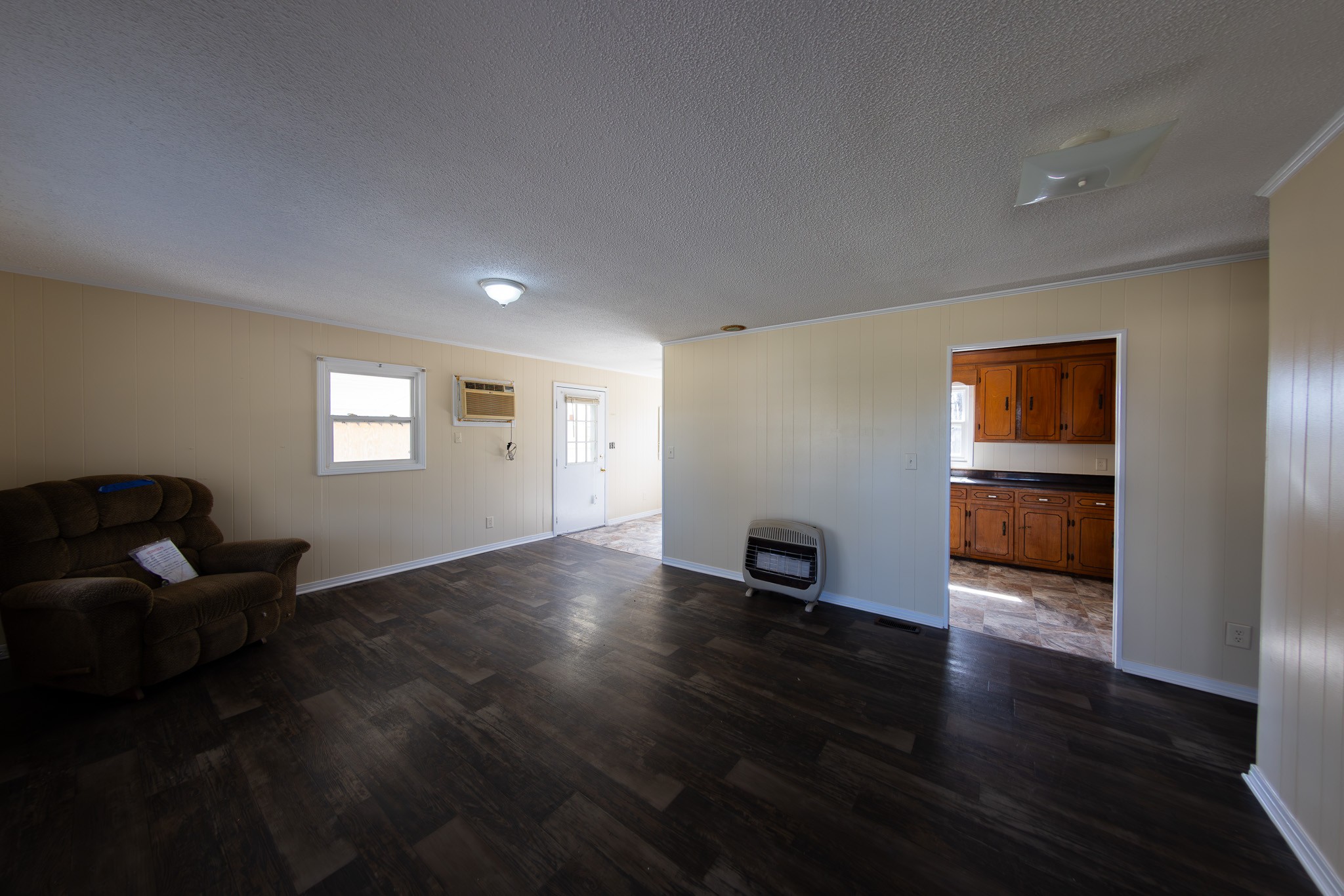674 Switzerland Road Hohenwald, TN 38462 - Photo 9 of 38 a view of an empty room with wooden floor and a window