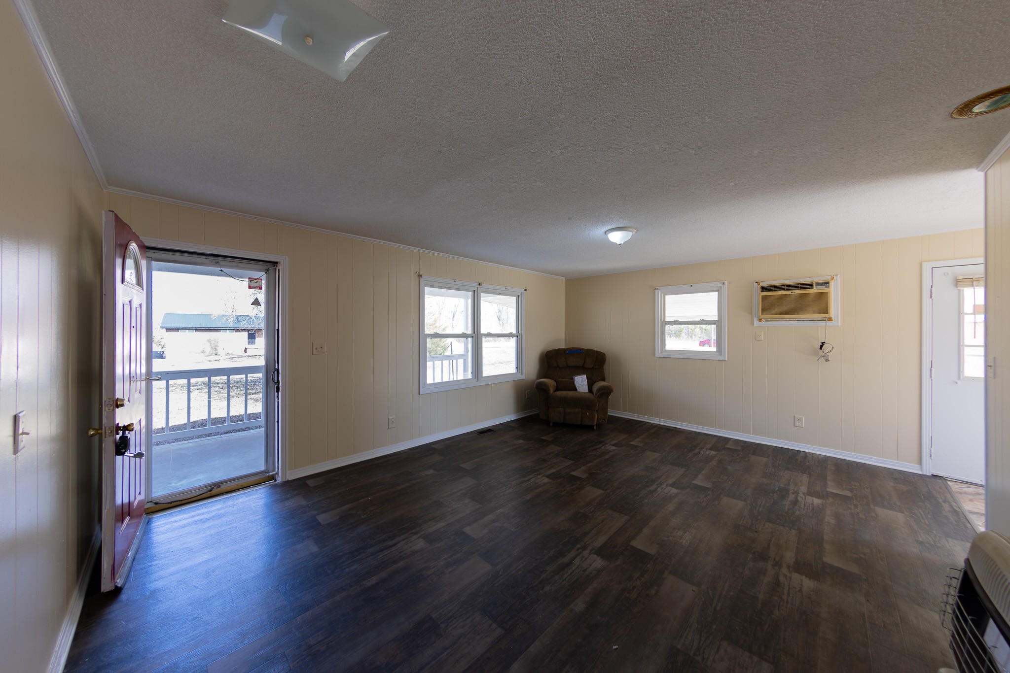 674 Switzerland Road Hohenwald, TN 38462 - Photo 10 of 38 an empty room with windows and a fireplace