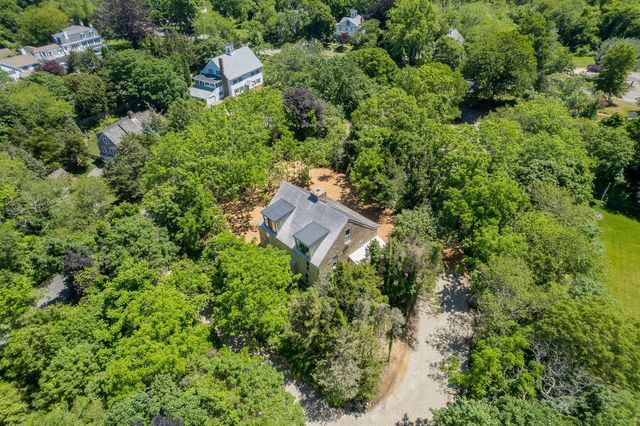 an aerial view of a house with a yard