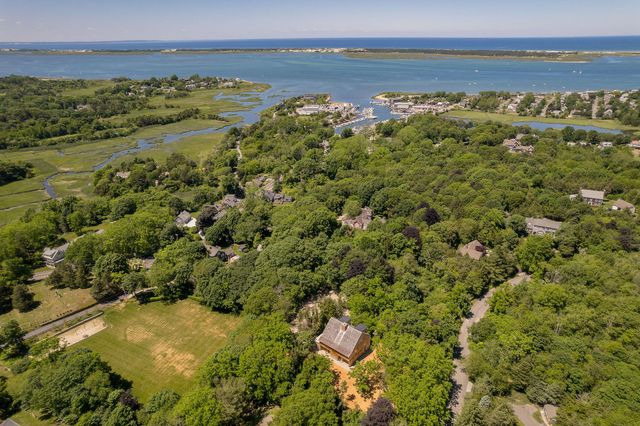 an aerial view of a house with a yard