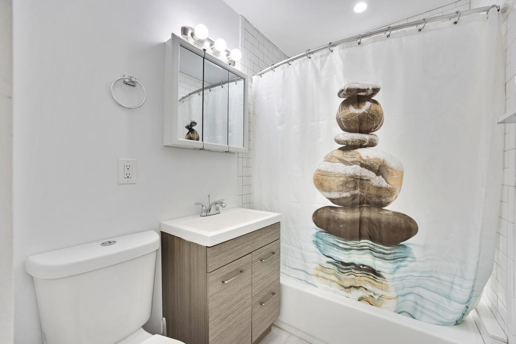 623 Thomas Street, Unit C Key West, FL 33040 - Photo 15 of 25 a bathroom with a sink and a mirror