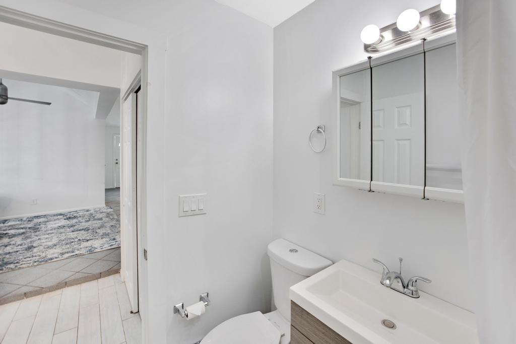 623 Thomas Street, Unit C Key West, FL 33040 - Photo 16 of 25 a bathroom with a sink a toilet and shower
