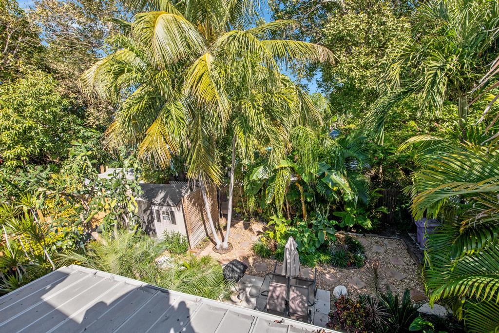 623 Thomas Street, Unit C Key West, FL 33040 - Photo 20 of 25 a view of a yard with plants and trees