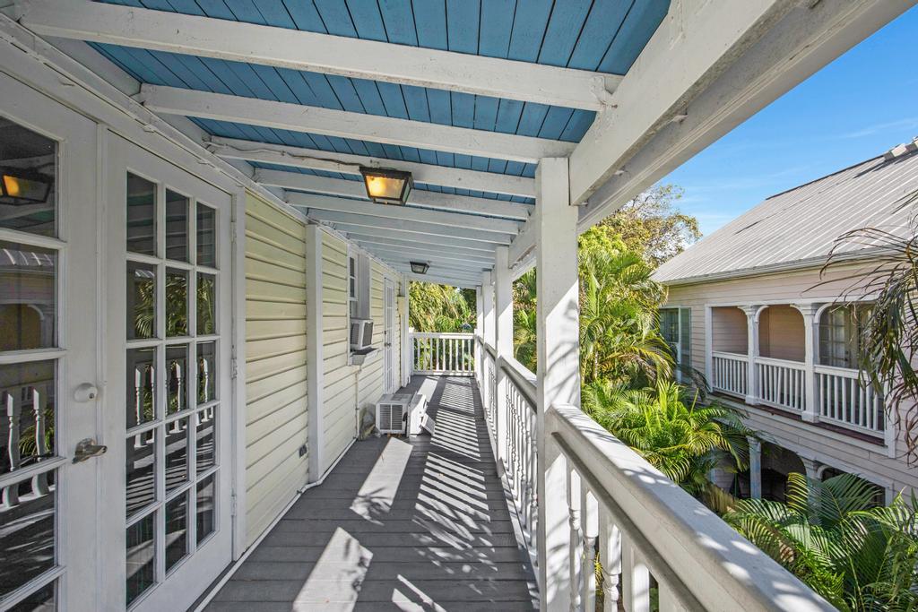 623 Thomas Street, Unit C Key West, FL 33040 - Photo 22 of 25 a view of a balcony with chairs