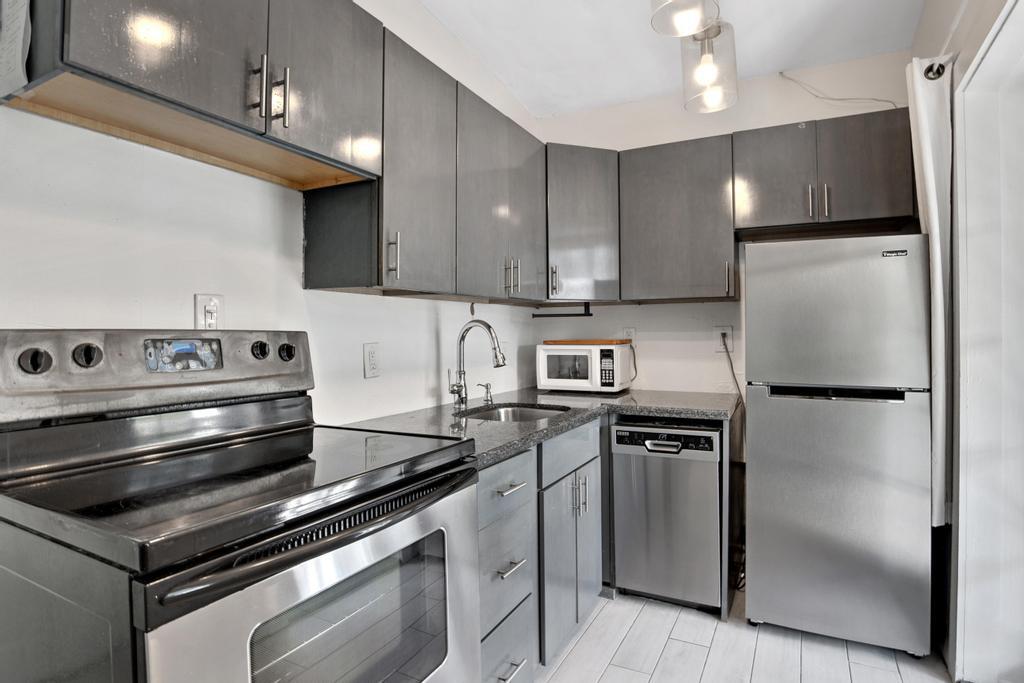 623 Thomas Street, Unit C Key West, FL 33040 - Photo 7 of 25 a kitchen with appliances and cabinets
