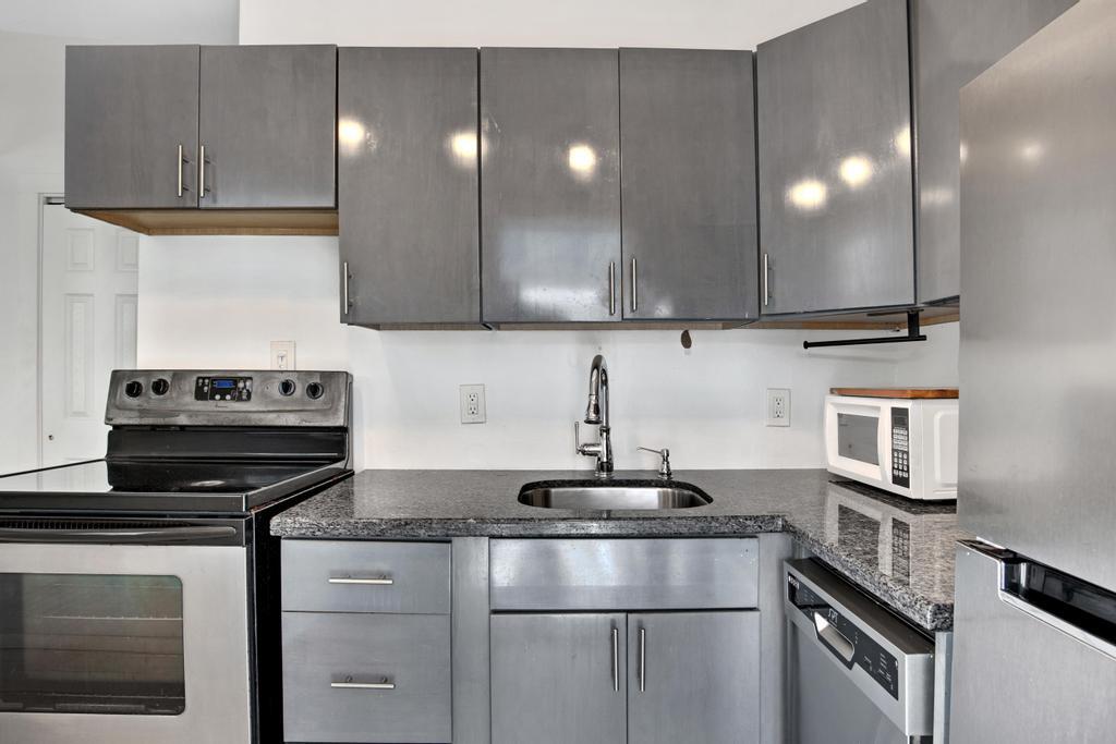 623 Thomas Street, Unit C Key West, FL 33040 - Photo 8 of 25 a kitchen with a stove and a sink