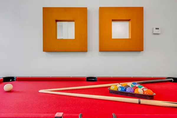 a room with pool table and window