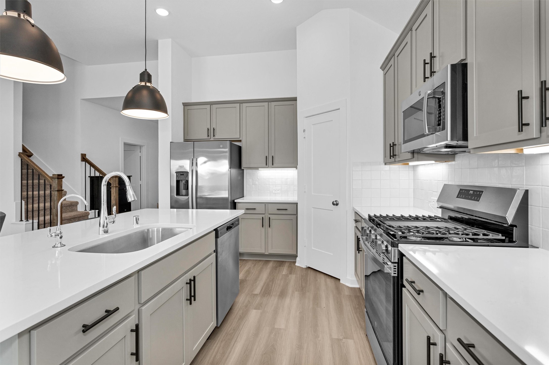 2127 Heather Rdg Way Rosenberg, TX 77471 - Photo 12 of 41 a kitchen with stainless steel appliances granite countertop a sink stove and refrigerator