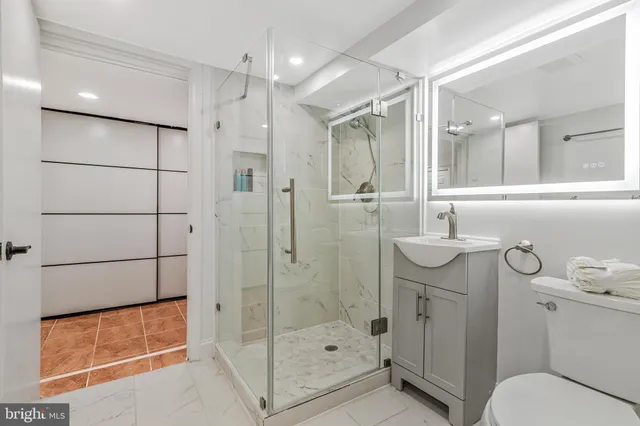 a bathroom with a shower sink and mirror