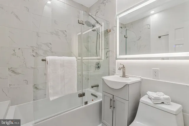 a bathroom with a sink toilet tub and shower