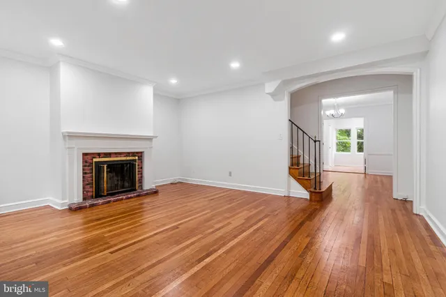 a view of a room with wooden floor and fireplace