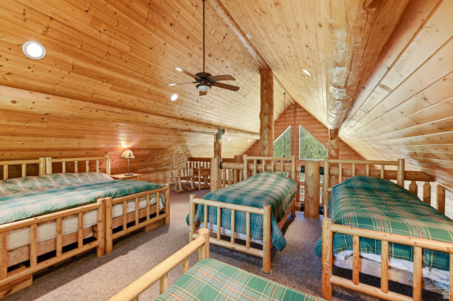 2096 South Aspen Ridge Coalville, UT 84017 - Photo 21 of 44 Loft space featuring extensive wood paneling and exposed log structural elements
