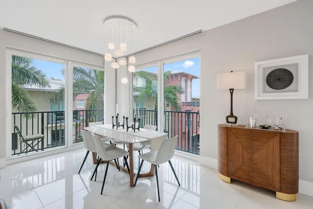 a dining area with a large window table and chairs
