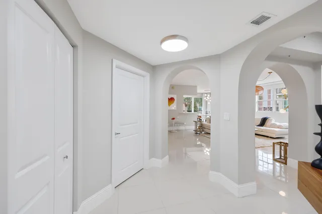 wooden floor with white walls and windows