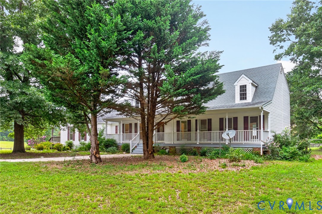 White siding exterior with a dark shingle roof, a