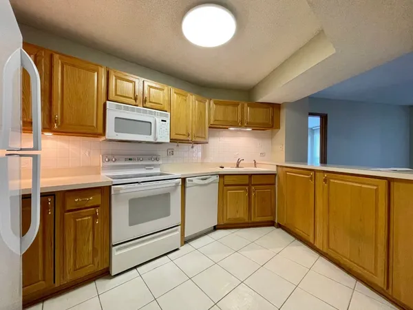 a kitchen with granite countertop cabinets stainless steel appliances and a counter space